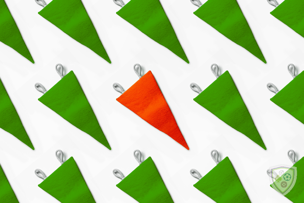 A white background with rows of green pennant-style sports flags. The middle flag is red, suggestive of the red flags you should look for when choosing a safe legal trustworthy US sports betting site.